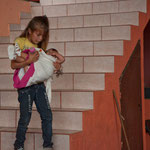 This girl carries her brother - with a lot of caution